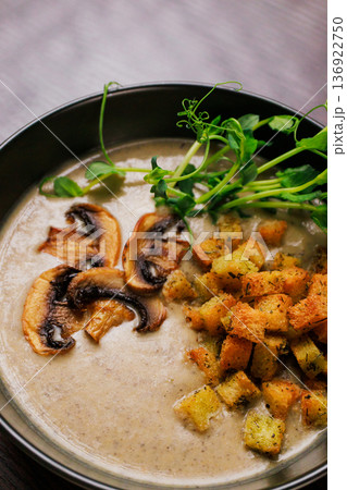 Cream soup with mushrooms and herbs in a black Cream soup with mushrooms and herbs in a black 136922750