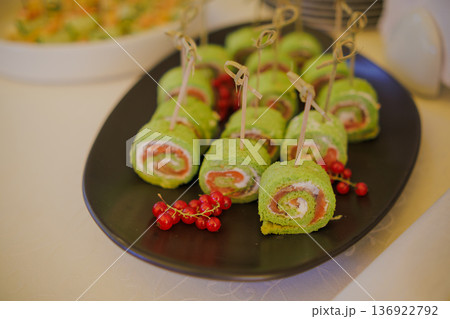 Appetizing rolls with red fish on a plate Appetizing rolls with red fish on a plate 136922792