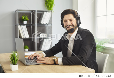 Remote work of call center operator, customer support or businessman with headset in office 136922938