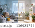 Split living room illustrates seasonal transformation: left side snowy and cluttered with boxes 136923754