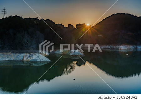 2026早春　渇水が続く布目ダムで対岸の山並みに沈んで行く夕日⑩ 136924842