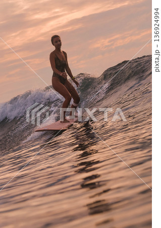 Woman Enjoying Sunset With Joyful Expression And Peaceful Coastal Surroundings Woman Enjoying Sunset With Joyful Expression And Peaceful Coastal Surroundings 136924994