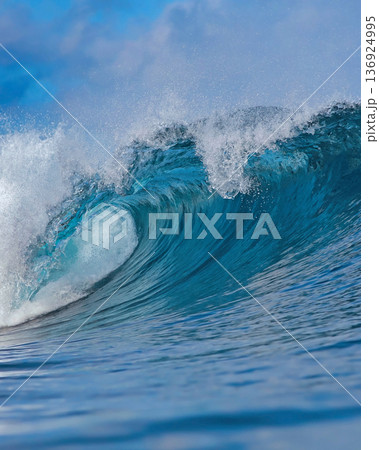 Majestic ocean swell with shimmering sunlight and foamy crest Majestic ocean swell with shimmering sunlight and foamy crest 136924995
