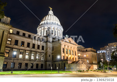 Mississippi State Capitol building stands in Jackson, USA. Historic Beaux-Arts architecture features the illuminated dome and stone columns under a dark night sky Mississippi State Capitol building stands in Jackson, USA. Historic Beaux-Arts architecture features the illuminated dome and stone columns under a dark night sky 136925018