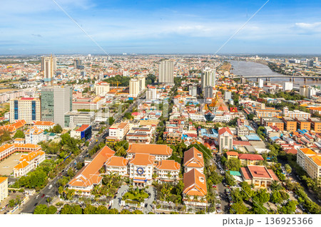 Modern residential areas and office buildings with Tonle Sap river in the background in rapidly developing Phnom Penh city panorama, Cambodia 136925366