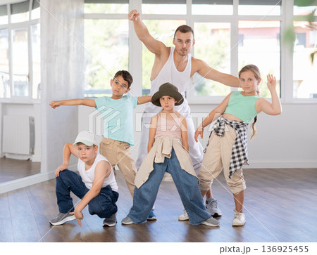 Group of preteen boys and girls hip hop dancers posing in dance studio Group of preteen boys and girls hip hop dancers posing in dance studio 136925455