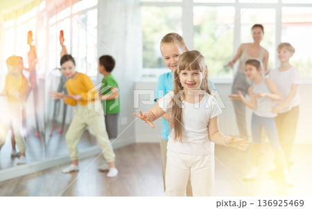Girl paired up with boy and training to perform boogie woogie couple dance, rehearse performance. Girl paired up with boy and training to perform boogie woogie couple dance, rehearse performance. 136925469