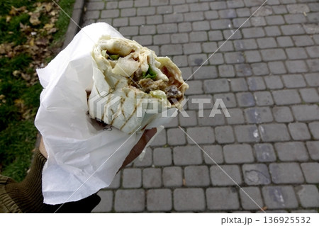 Savoring Doner Kebab Street Food on a Cobblestone Path 136925532