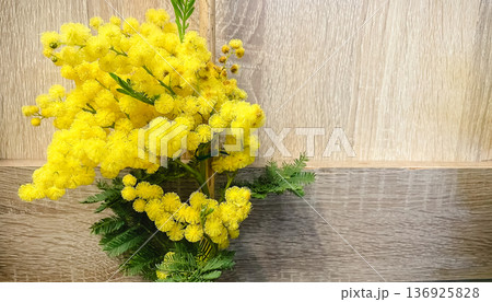 Bright yellow mimosa flowers on a wooden background, spring floral composition with copy space. Bright yellow mimosa flowers on a wooden background, spring floral composition with copy space. 136925828
