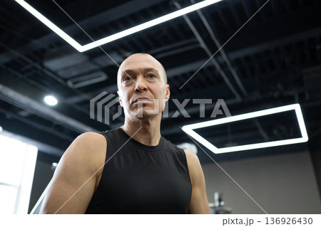 Muscular athletic man portrait in modern fitness gym Muscular athletic man portrait in modern fitness gym 136926430