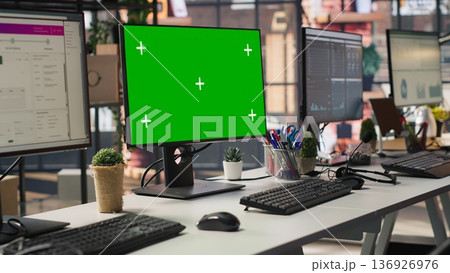 Isolated screen computer displays in customer support workplace, panning shot. Chroma key PC monitors in empty call center office where unsatisfied customers call to solve technical problems 136926976