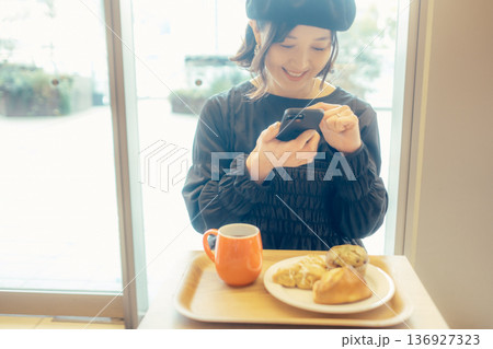 カフェでパンの写真を撮る日本人女性 カフェでパンの写真を撮る日本人女性 136927323