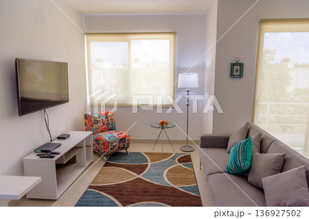 Cozy living room interior with wall mounted television 136927502