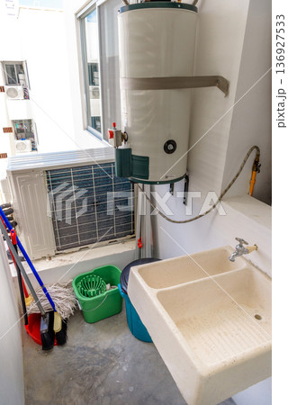 Utility room with water heater air conditioner and cleaning supplies 136927533