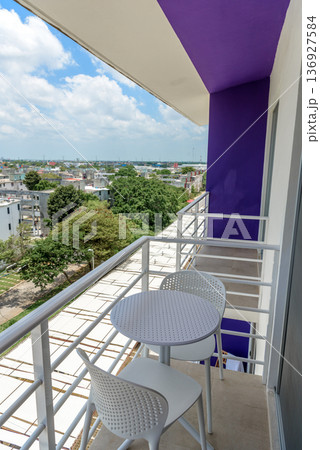 Small apartment balcony with table and city view Small apartment balcony with table and city view 136927584