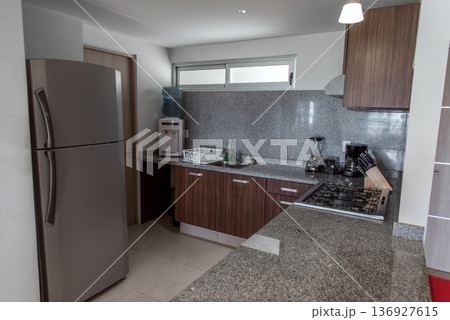 Modern kitchen with granite counters and wood cabinets view Modern kitchen with granite counters and wood cabinets view 136927615