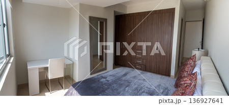 Modern bedroom interior with desk and large wardrobe Modern bedroom interior with desk and large wardrobe 136927641