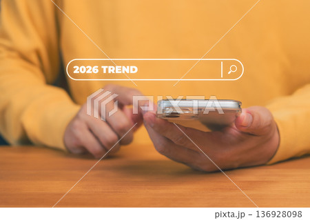 Person using smartphone with 2026 Trend search bar interface, symbolizing search engine optimization, digital marketing strategy, website ranking, and online business growth. 136928098