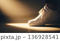 White sneaker stepping forward into bright spotlight 136928541