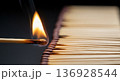Burning match igniting a row of matchsticks 136928544