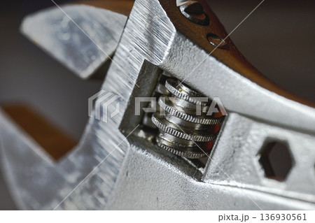 Detailed macro view of an adjustable wrench head showing the screw mechanism and metal texture Detailed macro view of an adjustable wrench head showing the screw mechanism and metal texture 136930561