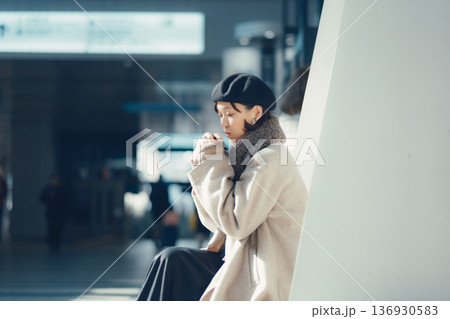 駅構内で待ち合わせをする冬の女性 136930583