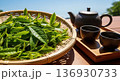 青空の茶畑と摘みたての新鮮な茶葉と急須・湯飲みのある日本茶イメージ 136930733