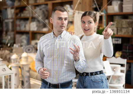 Couple inspect furniture store, searching for perfect item to buying. Couple inspect furniture store, searching for perfect item to buying. 136931134