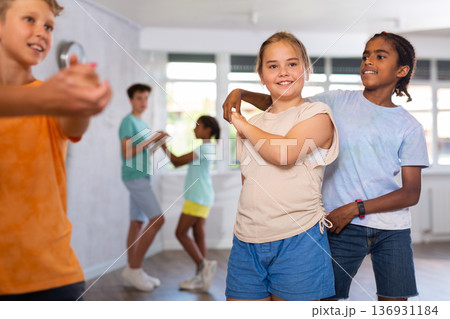 African boy and European girlie learn figures of pair jive dance and train before competition African boy and European girlie learn figures of pair jive dance and train before competition 136931184