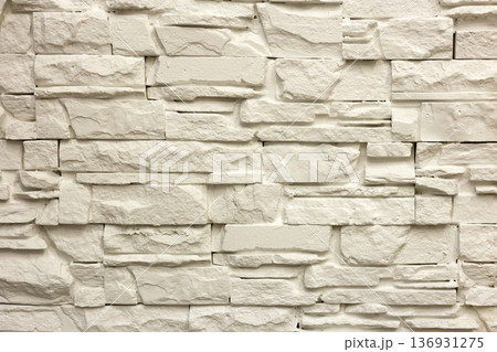 Close-up of white solid limestone wall or stone fence. Abstract copy space background, Bricklaying, construction and masonry concept. 136931275