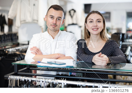 Couple man and woman posing in clothing store Couple man and woman posing in clothing store 136931276