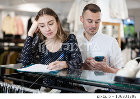 Couple woman and man with phone signing document 136931298