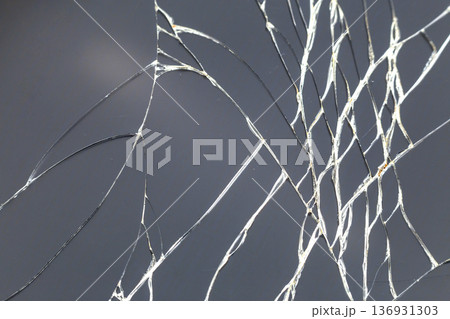 Abstract pattern dark gray background. Crackled screen of mobile cellphone. Gadget repair and maintenance concept. Abstract pattern dark gray background. Crackled screen of mobile cellphone. Gadget repair and maintenance concept. 136931303