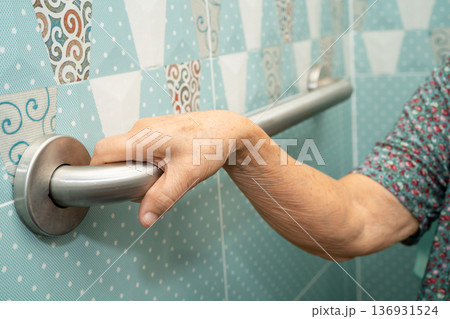 Asian elderly woman patient use toilet bathroom handle security in nursing hospital, healthy strong medical. 136931524
