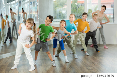 Preteen children engaged in choreography exercises in group Preteen children engaged in choreography exercises in group 136931619