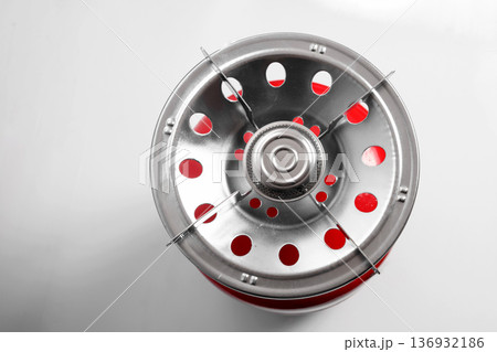 top view of a gas burner nozzle and the red body of the cylinder 136932186