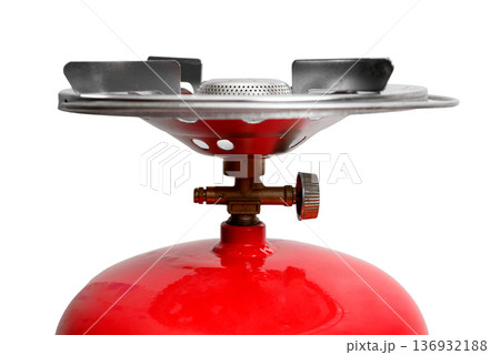 close up of the top of a red cylinder with a brass tap and a stove close up of the top of a red cylinder with a brass tap and a stove 136932188