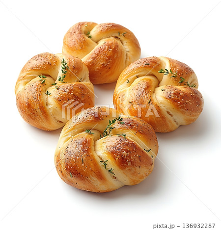 Freshly Baked Herb Knots with Golden Brown Surface and Sprigs of Thyme on White Background Freshly Baked Herb Knots with Golden Brown Surface and Sprigs of Thyme on White Background 136932287