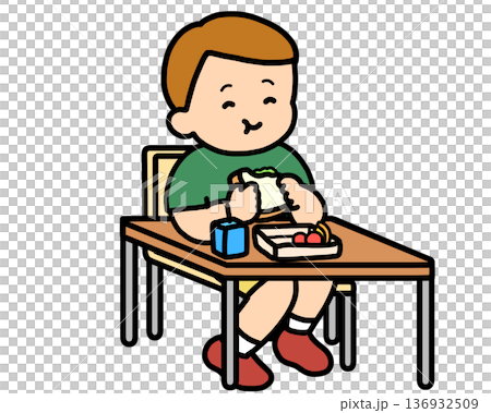 午餐時間:一個棕髮男孩在辦公桌前吃三明治。 午餐時間:一個棕髮男孩在辦公桌前吃三明治。 136932509