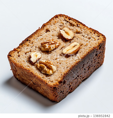 Delicious slice of homemade walnut cake on a clean white background, close-up view Delicious slice of homemade walnut cake on a clean white background, close-up view 136932842