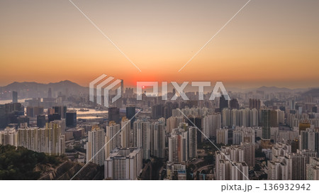 Jan 11 2026 Kowloon skyline glowing under warm golden sunset light Jan 11 2026 Kowloon skyline glowing under warm golden sunset light 136932942