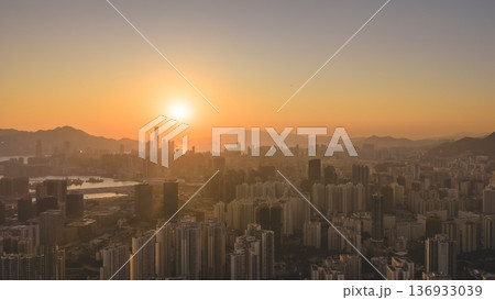 Jan 11 2026 Kowloon skyline glowing under warm golden sunset light Jan 11 2026 Kowloon skyline glowing under warm golden sunset light 136933039