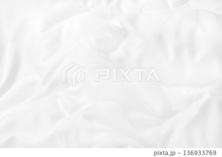 Close up top view of white bedding sheet and wrinkle messy blanket in bedroom after wake up in the morning. 136933769