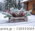 Christmas rustic decoration in wooden crate with frosted pine branches and red berries outdoors 136935669