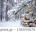 Christmas snow covered pine branch with frost and golden bokeh lights background 136935670