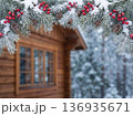Christmas Winter Background with Snowy Pine Branches and Blurred Wooden Cabin 136935671