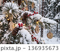 Christmas Snowy Pine Branches with Wooden Ornaments and Red Berries 136935673