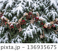 Christmas tree branches covered in snow with rustic pinecone berry and star decorations 136935675