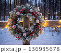 Christmas Wreath Decoration on Wooden Fence in Snowy Winter Forest 136935678