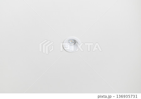 Minimalist white ceiling with single recessed light fixture, modern interior design, clean and simple atmosphere, soft illumination, contemporary home style 136935731